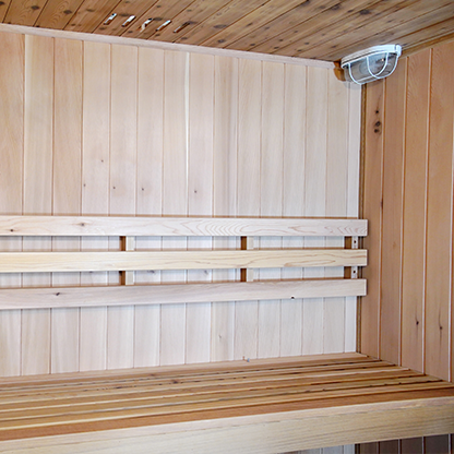 inside view of top bench and light inside of the Charleston 4-person traditional sauna in hemlock, double bench.