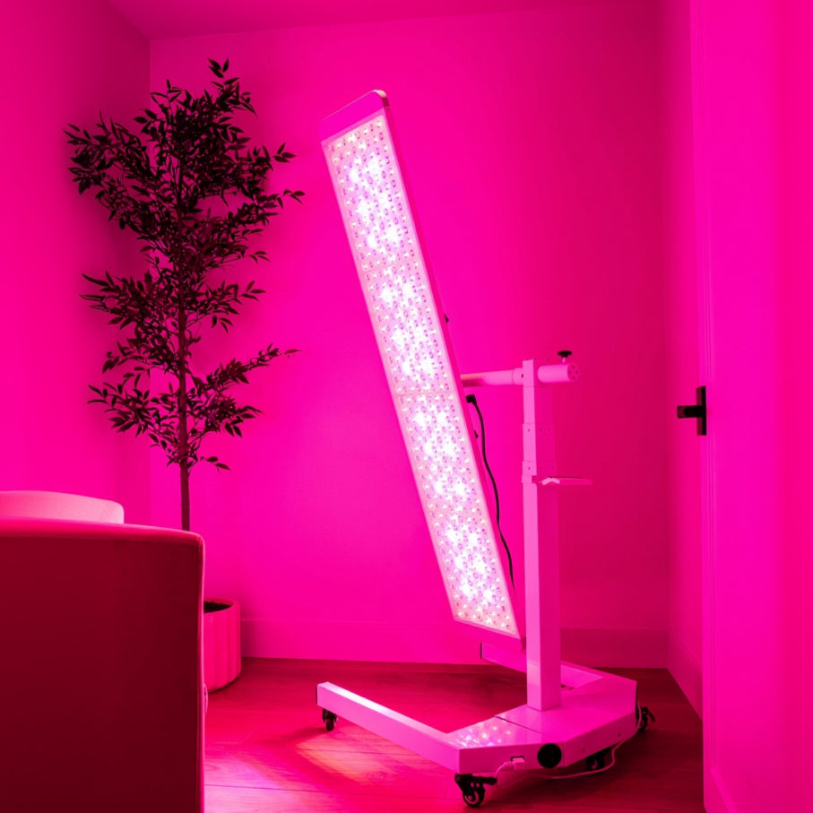 Red light therapy lamp in red-lit studio 